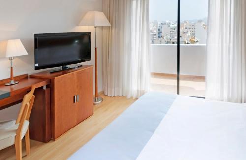 a hotel room with a bed and a television at Hotel Palma Bellver , Affiliated by Meliá in Palma de Mallorca