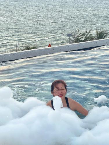 a young child is sitting in a cloud bathtub at Mandala Muine M2012A in Phan Thiet