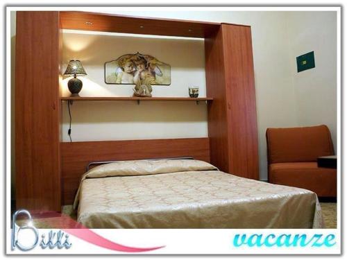 a bedroom with a bed and a mirror and a chair at Bitti vacanze in Castelvetrano Selinunte