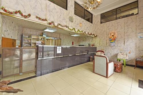 a restaurant with a counter and a chair in a room at Hotel O Villa De Rose in Johor Bahru