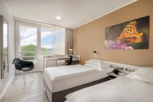 Postel nebo postele na pokoji v ubytování PARKHOTEL Hameln - ehemals Mercure Hotel Hameln