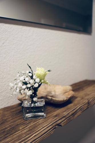 a vase filled with flowers sitting on a table at Ferienwohnung Sepp in Inzell