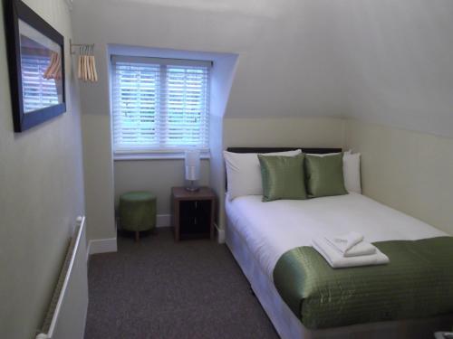 Кровать или кровати в номере The Stag Enfield
