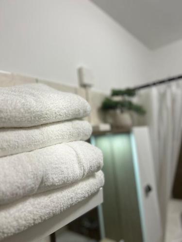 a stack of white towels on a table at SpaGo Apartment in Hajdúszoboszló