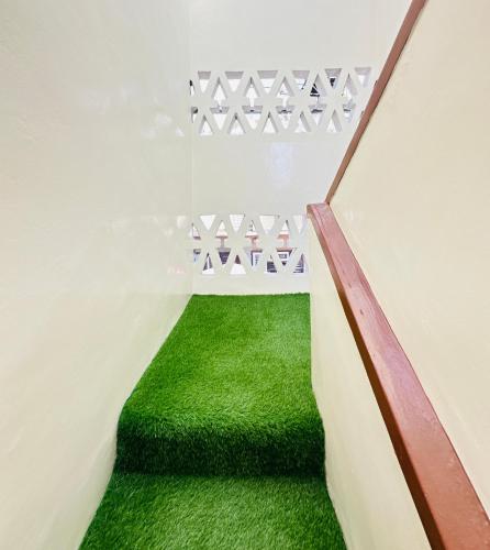 a stairway with green grass in a room at Yog Hostel- Rooftop Yoga & Backpacker Social Stay in Thamel, Kathamndu in Kathmandu