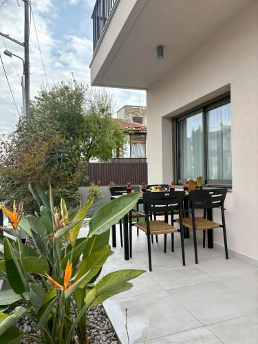 a patio with a black dining table and chairs at Maya Suites Potidaia in Nea Potidaea