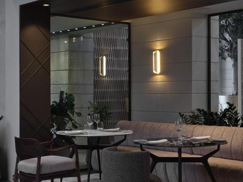a restaurant with two tables and a couch at September Hotel Thessaloniki in Thessaloniki