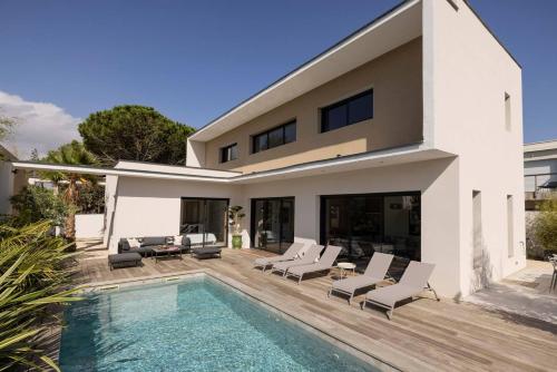 a villa with a swimming pool and a house at Villa Yuna Heated Swimming Pool Beach in Cap d'Agde