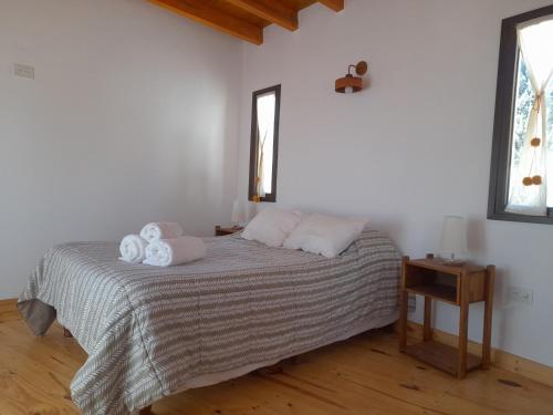 a bedroom with a bed with two towels on it at Casita para dos in Tilcara