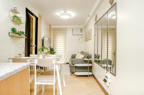 a kitchen and living room with a table and chairs at AR08 Smart Fully Furnished 1BR Condo in Davao City