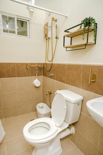a bathroom with a toilet and a sink at AR08 Smart Fully Furnished 1BR Condo in Davao City