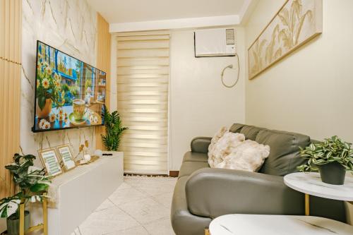 a living room with a couch and a table at AR08 Smart Fully Furnished 1BR Condo in Davao City