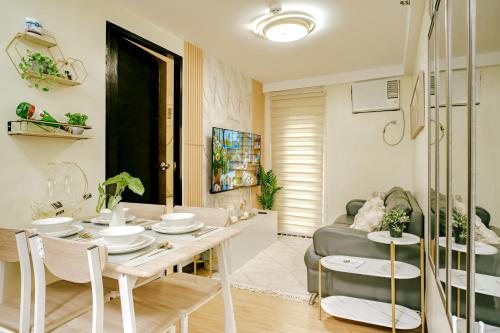 a living room with a table and a couch at AR08 Smart Fully Furnished 1BR Condo in Davao City