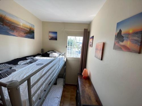 a bedroom with a bed and a window at Piscine 2 in Plan-de-la-Tour
