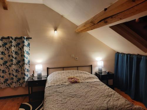 a bedroom with a bed with a teddy bear on it at La Bastide in Saint-Vincent-de-Tyrosse