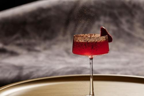 a red wine glass with a piece of food on it at September Hotel Thessaloniki in Thessaloniki