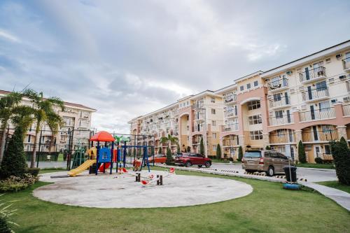 a playground in front of a large apartment building at AR08 Smart Fully Furnished 1BR Condo in Davao City