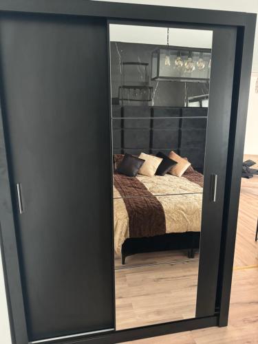 a mirror in front of a bedroom with a bed at Panama Apartments in Krefeld