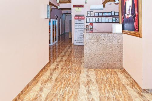 an empty hallway with wood floors in a pharmacy at OYO 139 Al Ghadeer Hotel Apartments in Barka