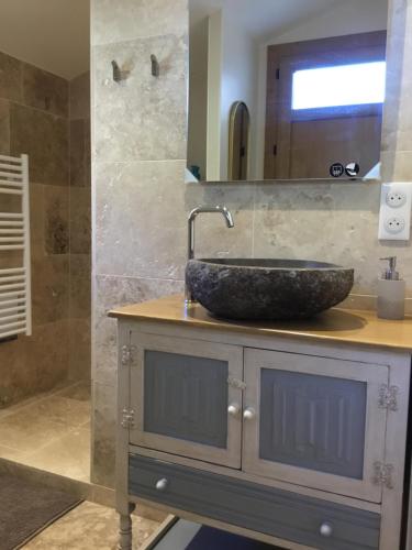 a bathroom with a stone sink on a counter at La Pierrerie Bambou in Tourtour