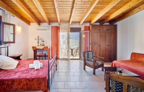 a large room with a bed and a table at Deluca Stone House in Gennadi