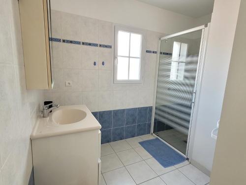 une salle de bain avec un lavabo et une douche dans l'établissement L'abri côtier, à Brem-sur-Mer