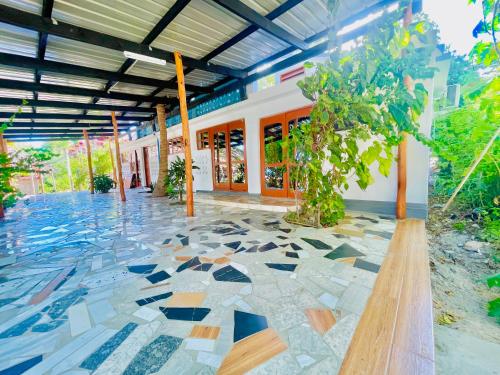 a building with a floor covered in mosaic tiles at Bush Beach Backpackers in Vilanculos