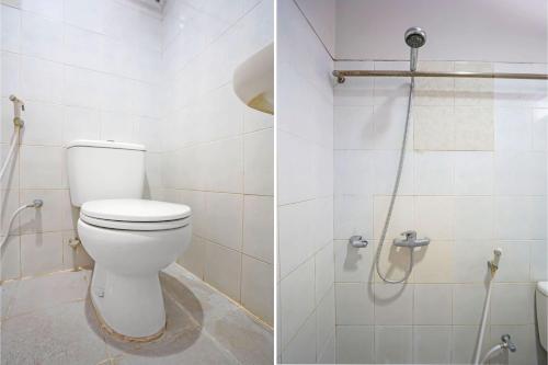 a bathroom with a toilet and a shower at Hotel O Anugerah in Jember