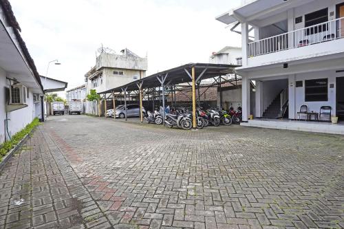 a group of motorcycles parked next to a building at Hotel O Anugerah in Jember