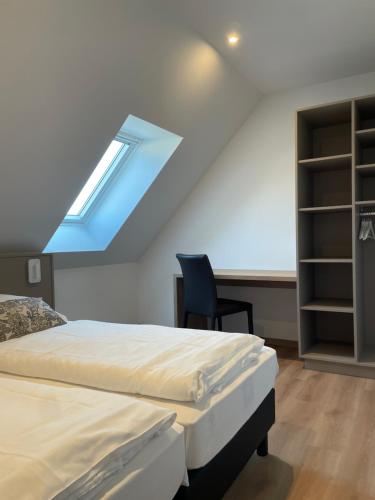a bedroom with two beds and a blue roof at La Clé des Vignes 2 in Ribeauvillé
