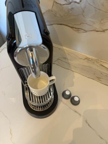 a hair dryer sitting on a counter with a cup at Duplex sur le Golfe de Saint Tropez - Panoramic View in Cogolin