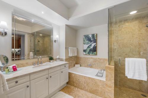 a bathroom with a tub and a sink and a shower at 1435 Brickell Ave 3004 in Miami