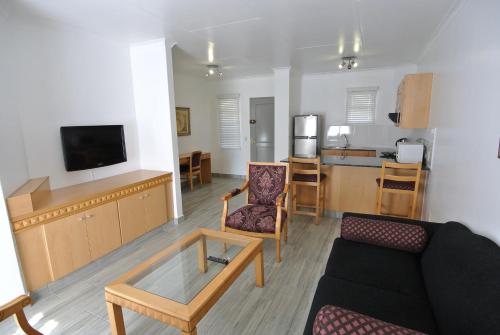 a living room with a couch and a table at Airport Inn and Suites in Johannesburg