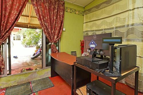 an office with a desk with a computer on it at Capital O 90664 Rabi Hotel in Kota Bharu