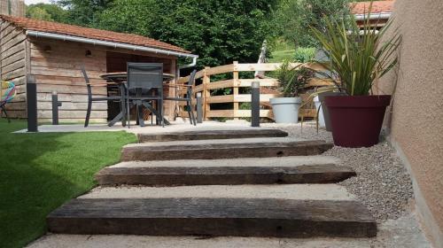 a set of stairs leading to a backyard with a table at La Villa des Roses au cœur de Cormoyeux in Cormoyeux