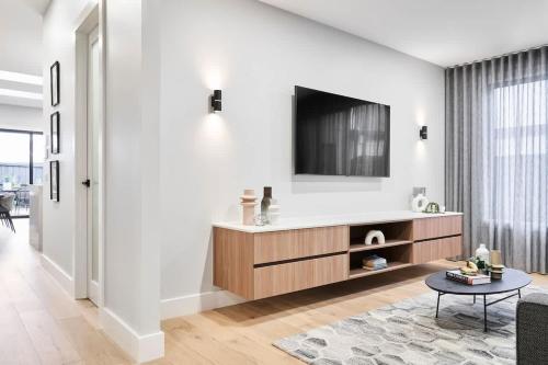 a living room with a tv on a wall at Sunbury Luxury - The Perfect Family Entertainer in Sunbury