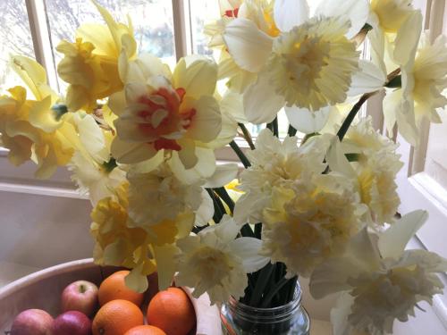 a vase filled with flowers and apples on a table at Temple Croft Bed and Breakfast in Alston