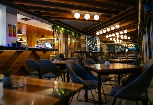 a restaurant with tables and chairs and a bar at City Palace Hotel in Ohrid