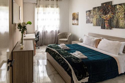 a bedroom with a large bed with a blue blanket at MADRIGIO... a casa propria in Casamassima