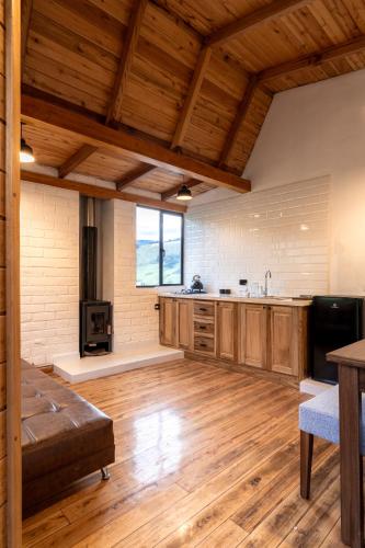 a large living room with wooden floors and a fireplace at Salinas Luxury Home in the Mountains in Guaranda