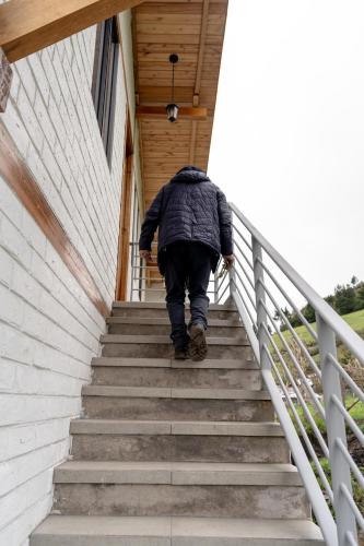 a man walking down a stairway at Salinas Luxury Home in the Mountains in Guaranda
