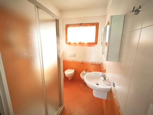a bathroom with a toilet and a sink and a shower at Berta in Rosolina