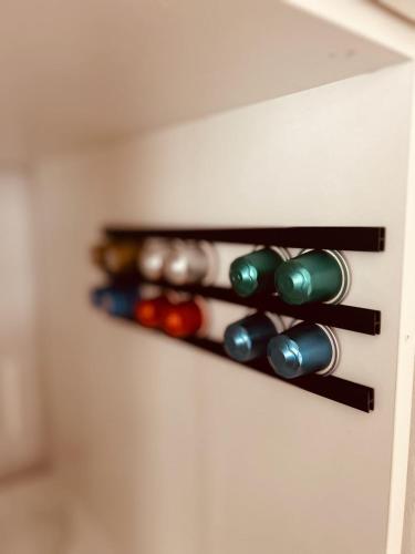 a row of wine bottles on a wall at AlbLoft - Modernes neues Apartment nahe City & Alb für bis zu 6 Personen in Kirchentellinsfurt in Kirchentellinsfurt