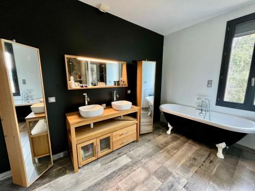 une salle de bain avec deux lavabos et une baignoire dans l'établissement Le Mas des platanes-piscine-gîte-Clim-parking, à Monteux