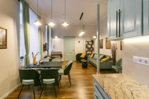a kitchen and living room with a table and chairs at Klimt's Puzzle Suite in Sofia