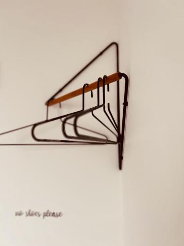 a metal shelf on a white wall at DachNest - Wundervolles neues Dachgeschoss Apartment für bis zu 4 Personen in Kirchentellinsfurt in Kirchentellinsfurt