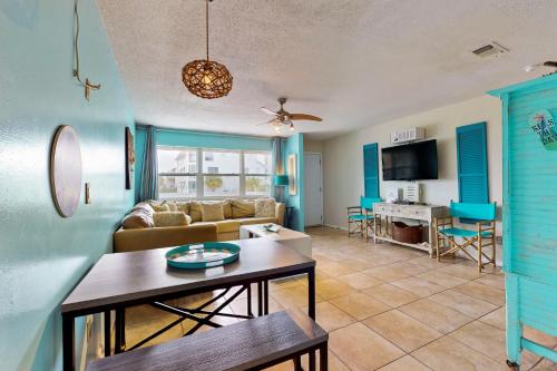 a living room with a couch and a table at Seas the Day in Navarre