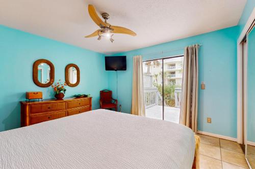 a bedroom with a bed and a ceiling fan at Seas the Day in Navarre