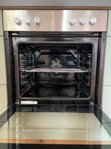 an oven with its door open in a kitchen at Aich21 in Peißenberg