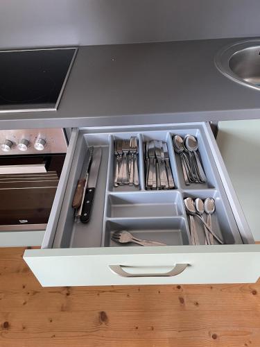 an open drawer in a kitchen with utensils at Aich21 in Peißenberg